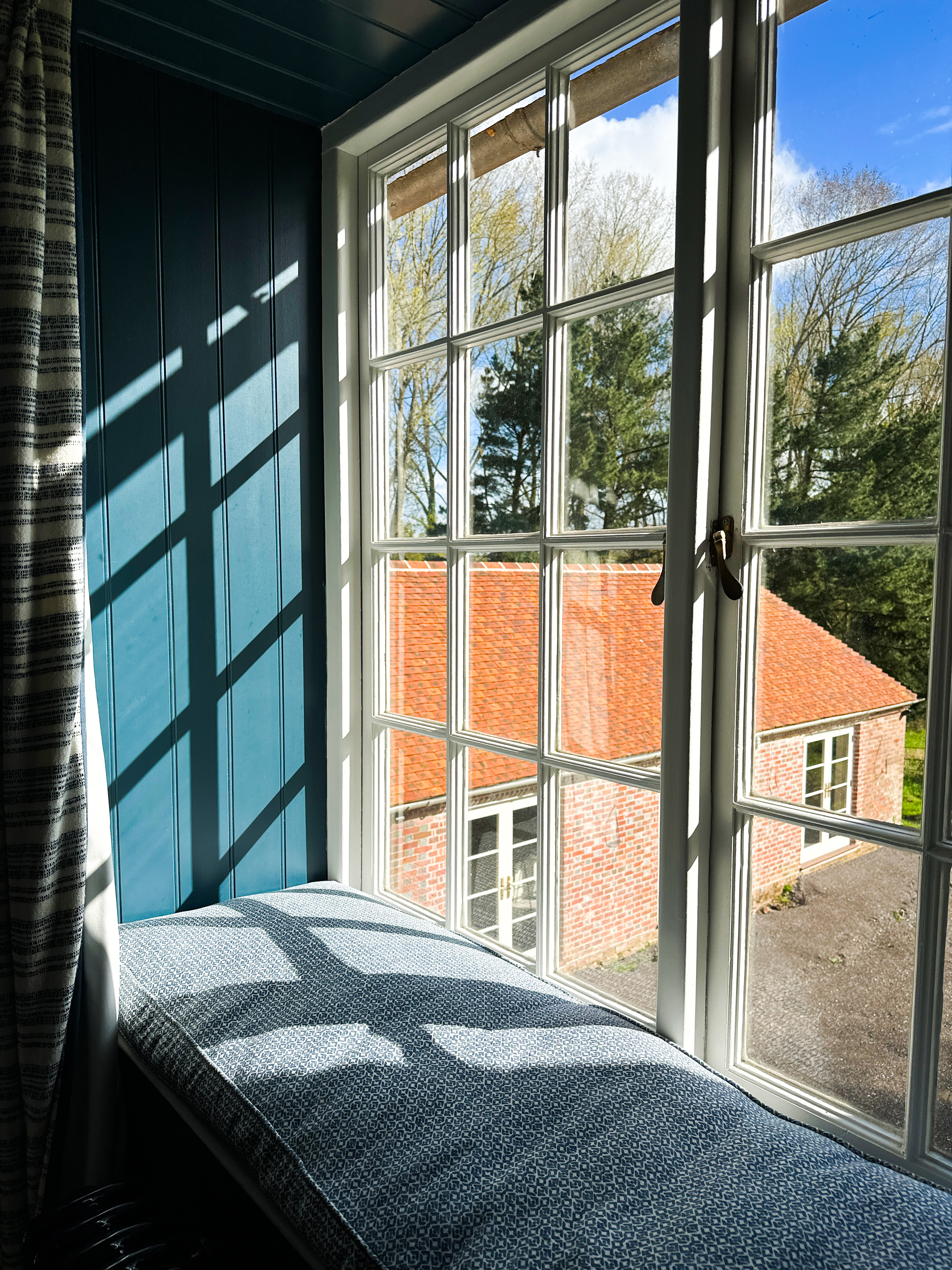 Window of a renovation project with a view of the kitchen room with a newly tiled roof.